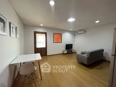 Spacious modern living room with wooden flooring and minimalist decor