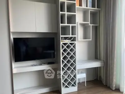 Modern living room with built-in TV unit and stylish shelving