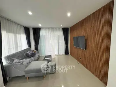 Modern living room with sleek wood paneling and large windows