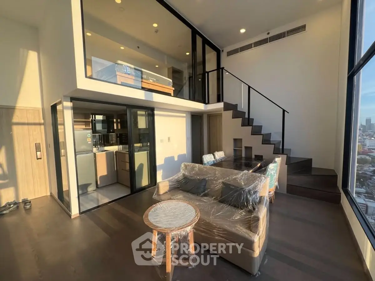 Stunning modern duplex with floor-to-ceiling windows and sleek interior design.