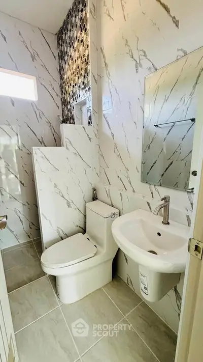 Modern bathroom with elegant marble tiles and sleek fixtures