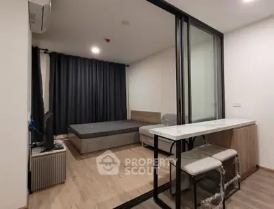 Modern bedroom with sliding glass doors and stylish furniture in a contemporary apartment.