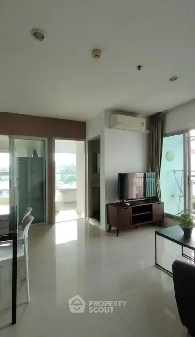 Spacious modern living room with natural light and balcony access