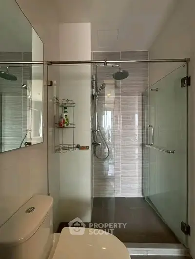 Modern bathroom with glass shower enclosure and sleek fixtures