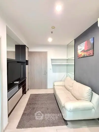 Modern living room with sleek design and cozy white sofa, perfect for relaxation and entertainment.