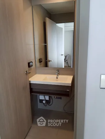 Modern compact bathroom with sleek sink and mirror design