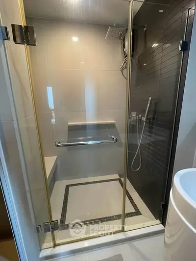 Modern bathroom with glass shower enclosure and sleek tile design