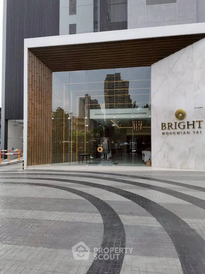 Modern building entrance with sleek design and glass facade at Bright Wongwian Yai.