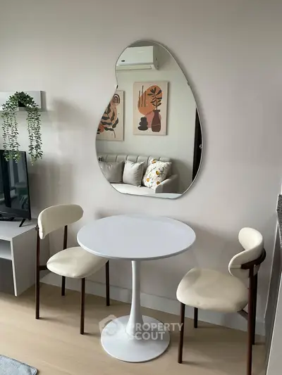 Modern living room with stylish furniture and unique mirror design, perfect for cozy gatherings.