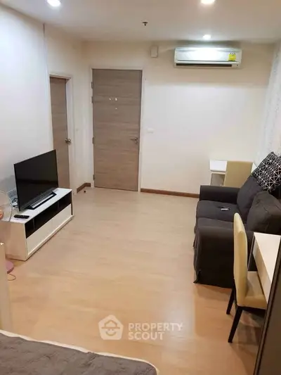 Modern living room with sleek furniture and air conditioning in a cozy apartment.