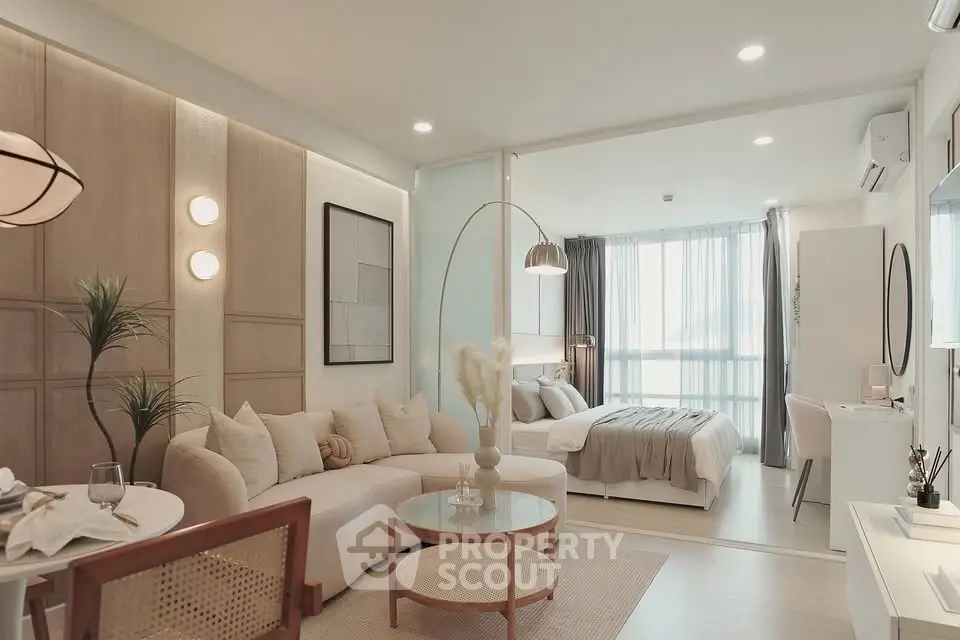 Modern open-plan living room and bedroom with stylish decor and natural light