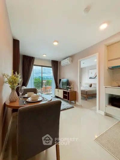 Modern open-plan living room with dining area and scenic balcony view