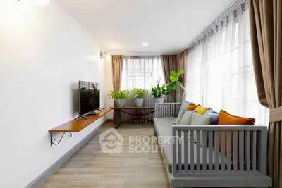 Spacious living room with modern decor and large windows for natural light.