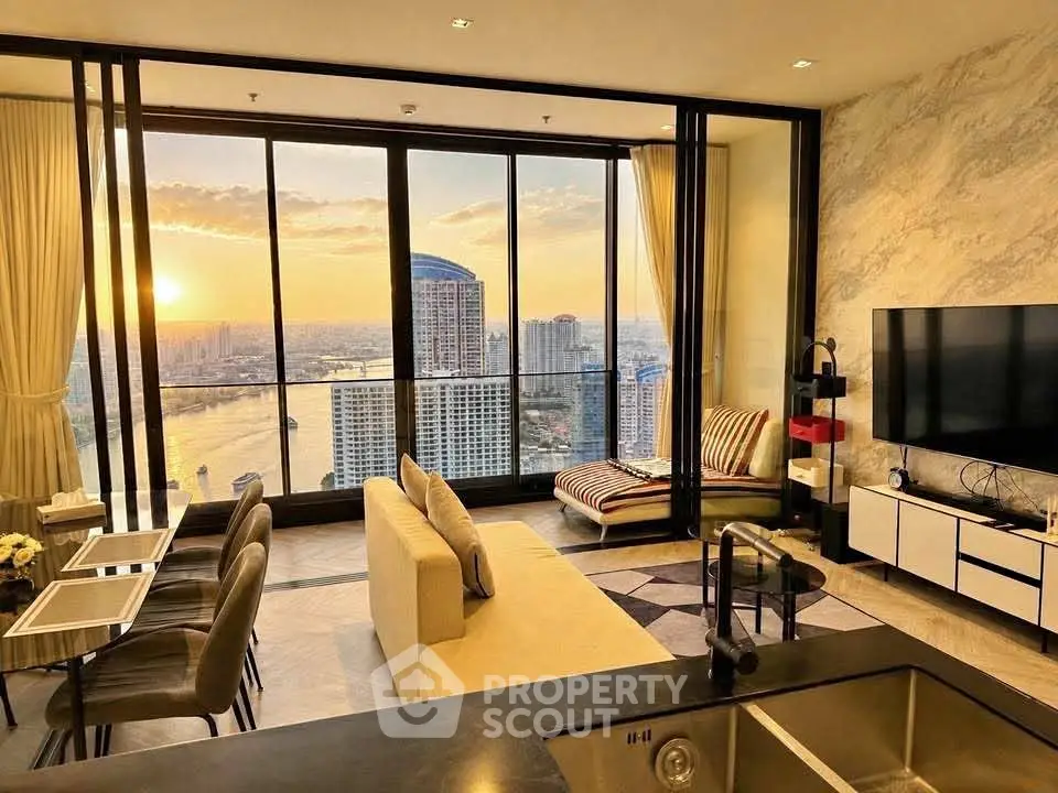 Luxurious living room with stunning city and river view, modern decor, and floor-to-ceiling windows.