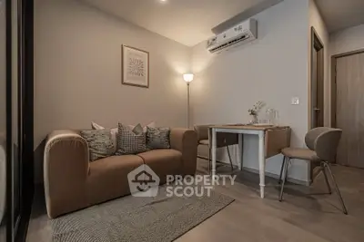 Cozy living room with modern decor and air conditioning, perfect for relaxation.