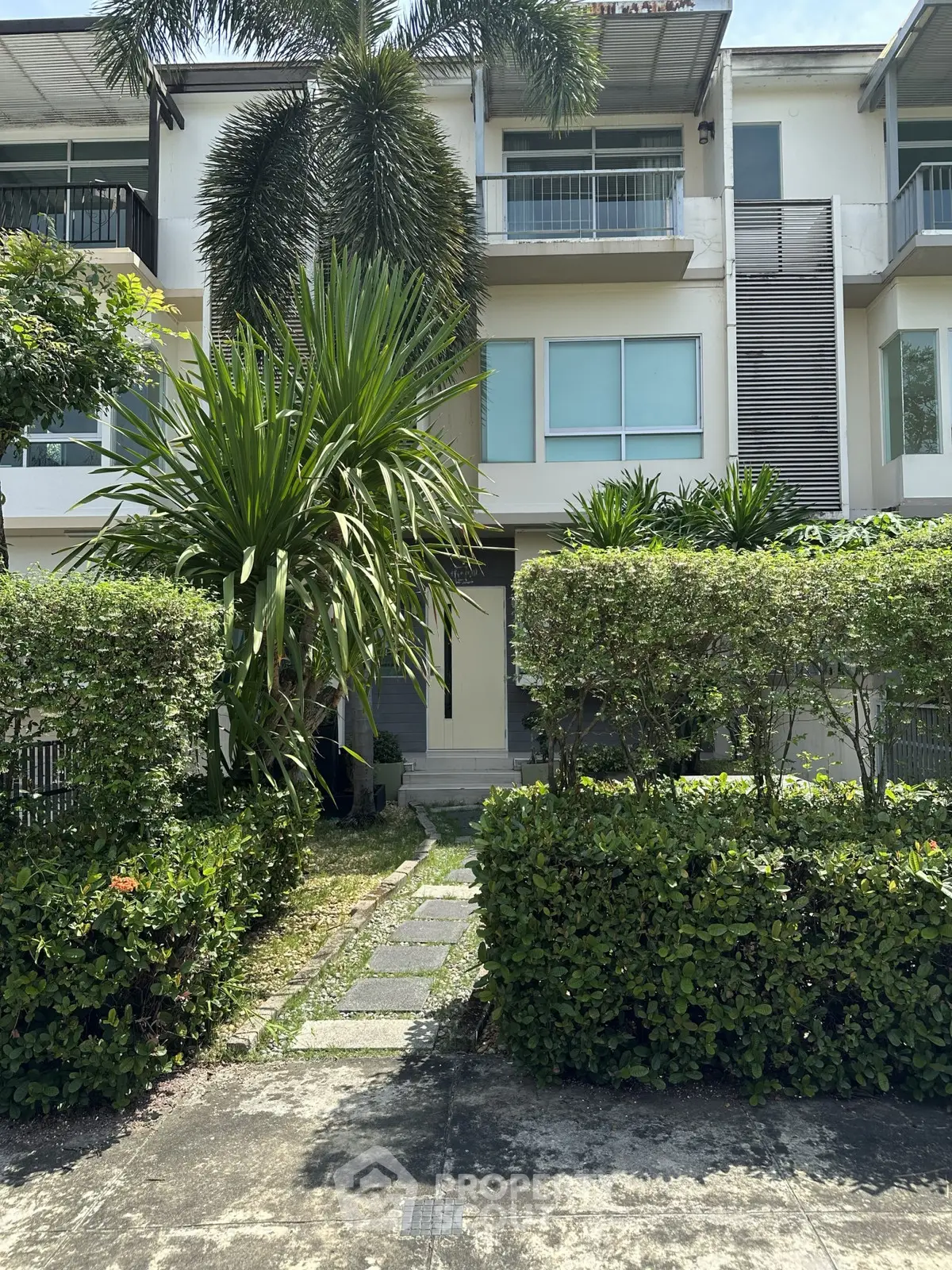 Modern townhouse with lush greenery and contemporary design