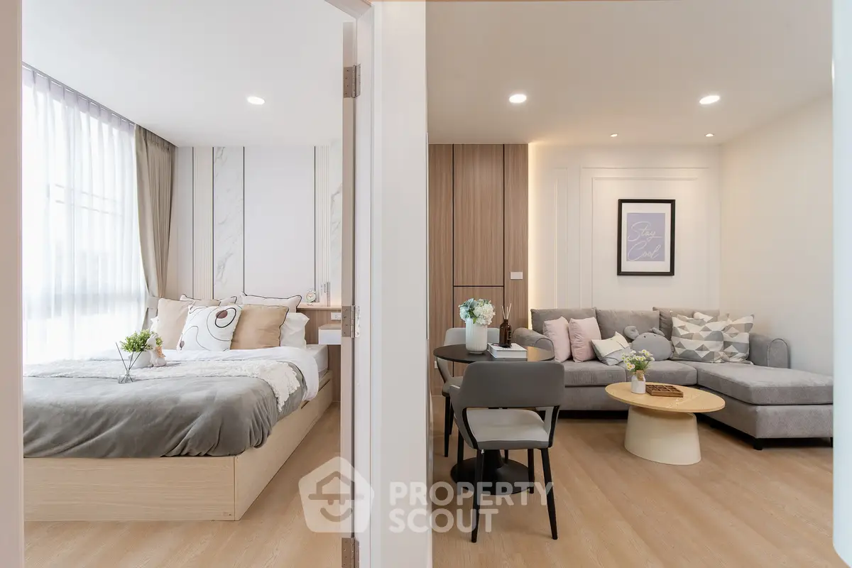 Modern open-concept living room and bedroom with stylish decor and natural light.