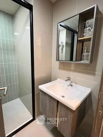 Modern bathroom with sleek sink and glass shower enclosure