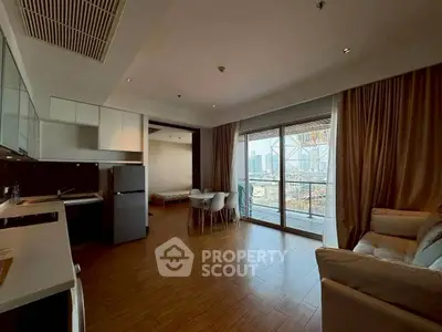 Modern open-plan living room with city view balcony in high-rise apartment.