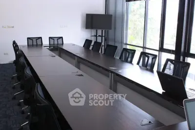Spacious modern conference room with large windows and sleek furniture