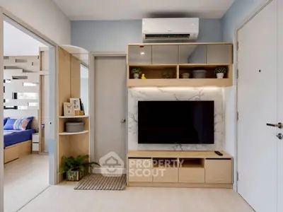 Modern living room with sleek TV unit and air conditioning, adjacent to a stylish bedroom.