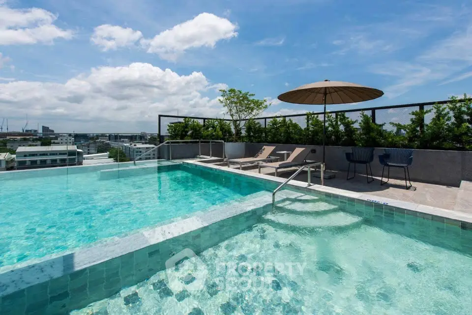 Luxurious rooftop pool with stunning city views and relaxing lounge area.
