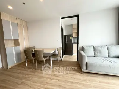 Modern living room with dining area and sleek kitchen in open layout apartment