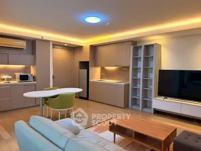 Modern open-layout living room with sleek kitchen and stylish furniture