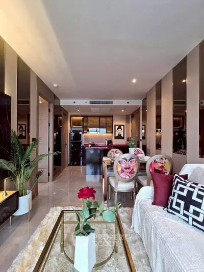 Luxurious open-plan living room with modern decor and elegant dining area