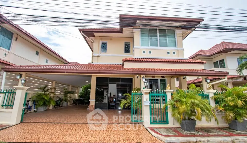 Charming two-story house with red-tiled roof and spacious driveway in a serene neighborhood.