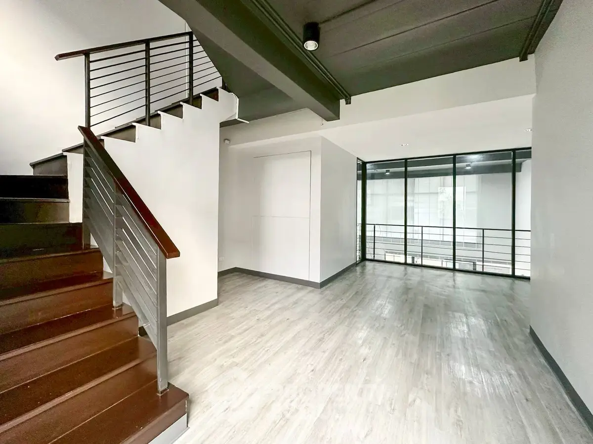 Spacious modern interior with sleek staircase and large windows