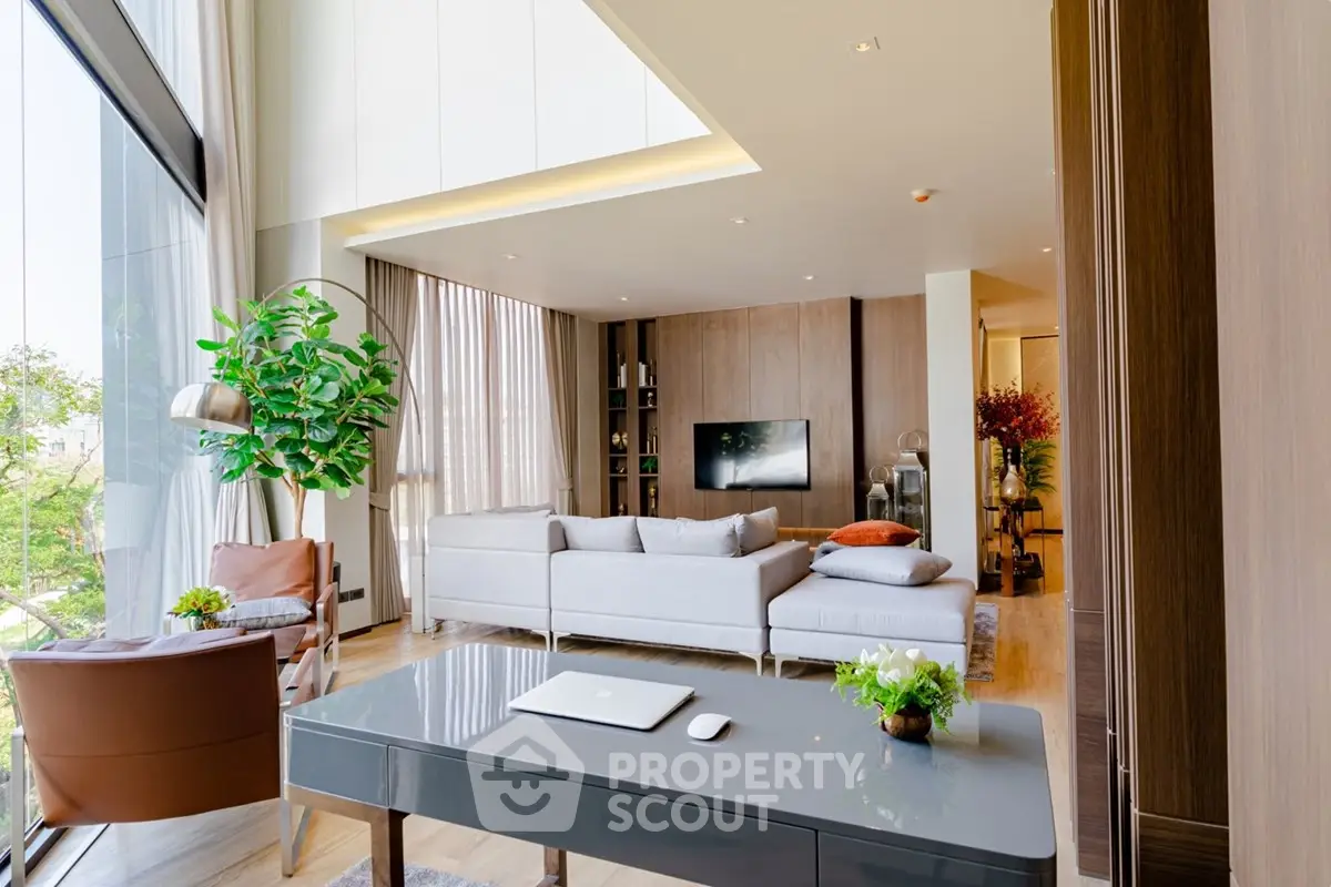 Spacious modern living room with large windows and stylish decor