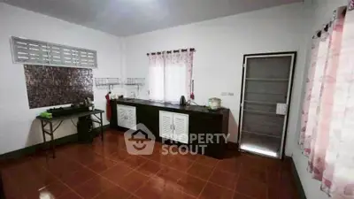 Spacious kitchen with tiled floor and modern cabinetry