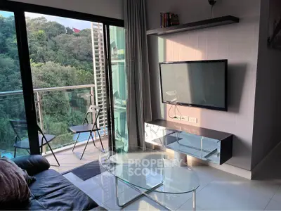 Modern living room with glass balcony overlooking lush greenery and pool