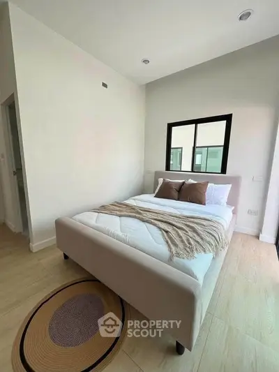 Modern bedroom with cozy bed and stylish decor in a bright apartment.
