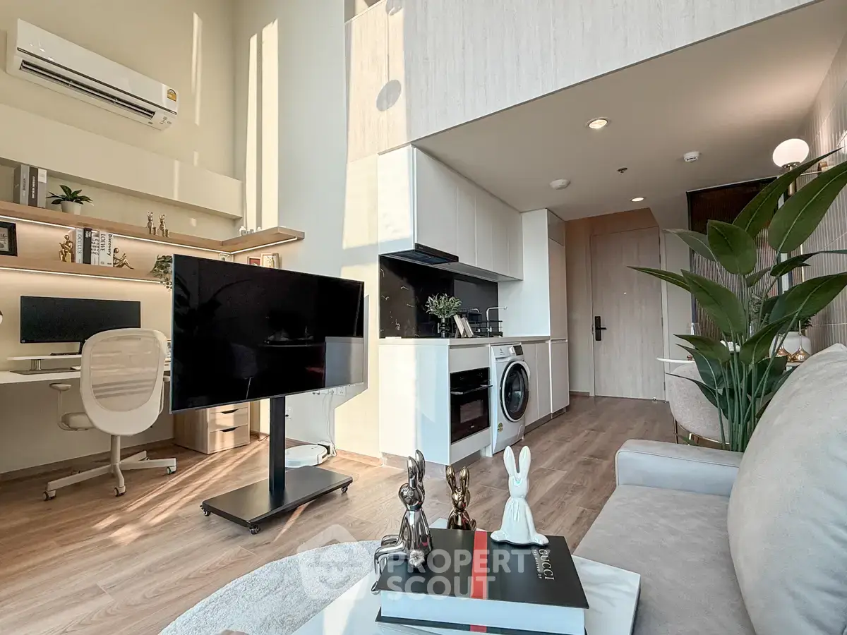 Modern living room with open kitchen, stylish decor, and natural light