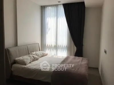Cozy bedroom with modern design and natural light through large window