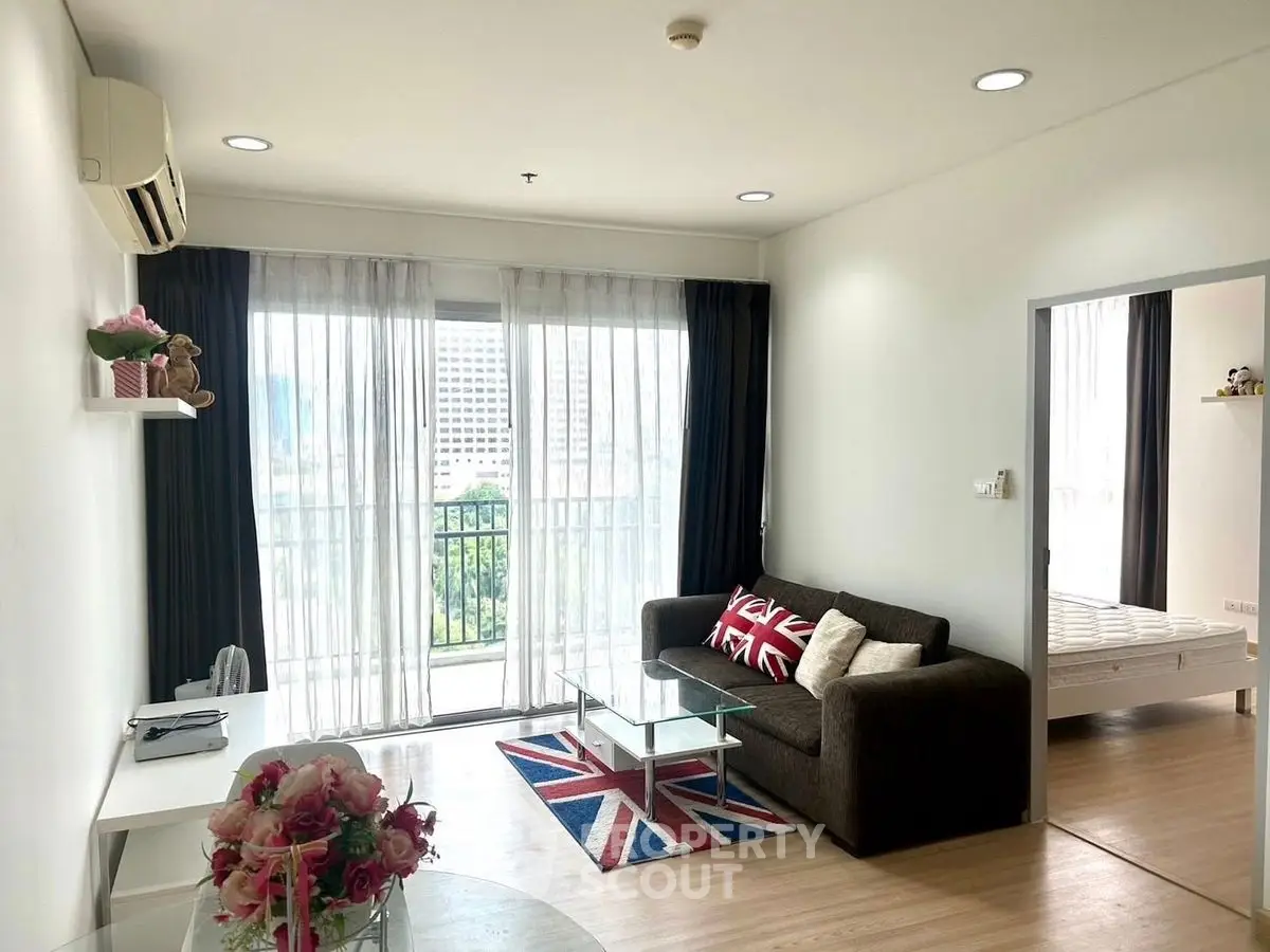 Bright living room with modern decor and balcony view in a stylish apartment.