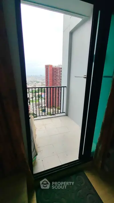 Modern apartment balcony with stunning city view and sleek railing design.