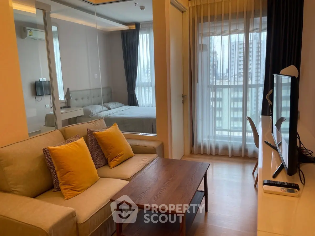 Modern apartment interior with cozy living room and bedroom, featuring large windows and stylish decor.