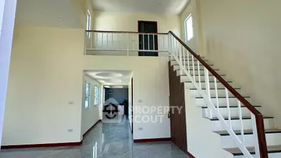 Spacious modern interior with elegant staircase and high ceilings