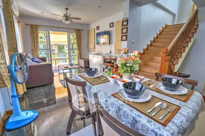 Charming open-plan living and dining area with elegant decor and natural light, perfect for family gatherings.
