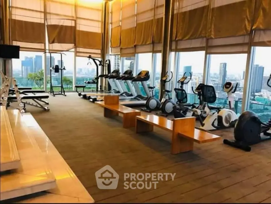 Luxurious high-rise gym with panoramic city views and modern fitness equipment.