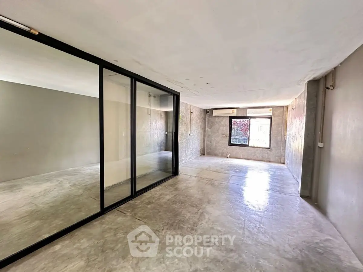 Spacious modern living room with large glass doors and minimalist design