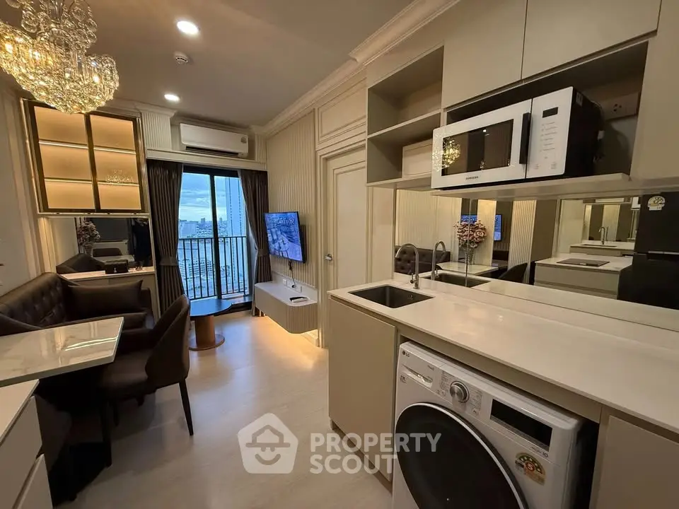 Luxurious modern living room with open kitchen, featuring elegant decor and city view balcony.