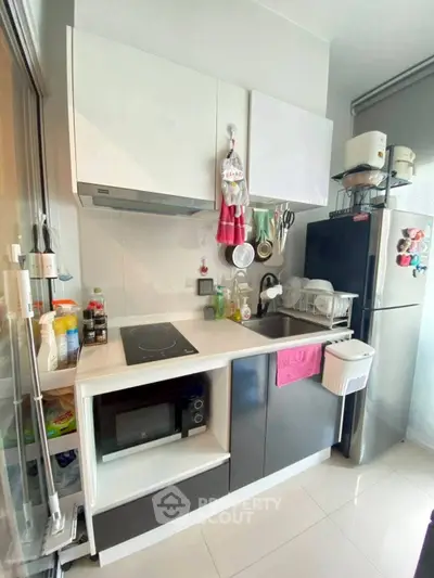 Modern compact kitchen with sleek appliances and ample storage space