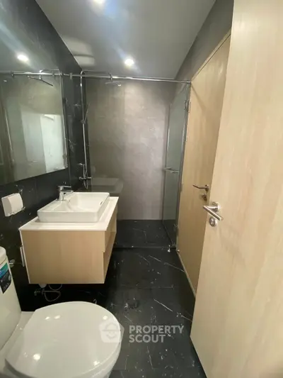 Modern bathroom with sleek black tiles and stylish fixtures