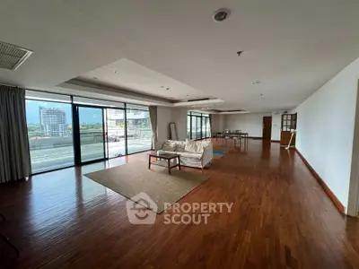 Spacious living room with hardwood floors and large balcony access