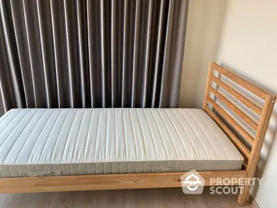 Minimalist single wooden bed with comfortable mattress in a serene bedroom setting, perfect for restful nights and modern living.