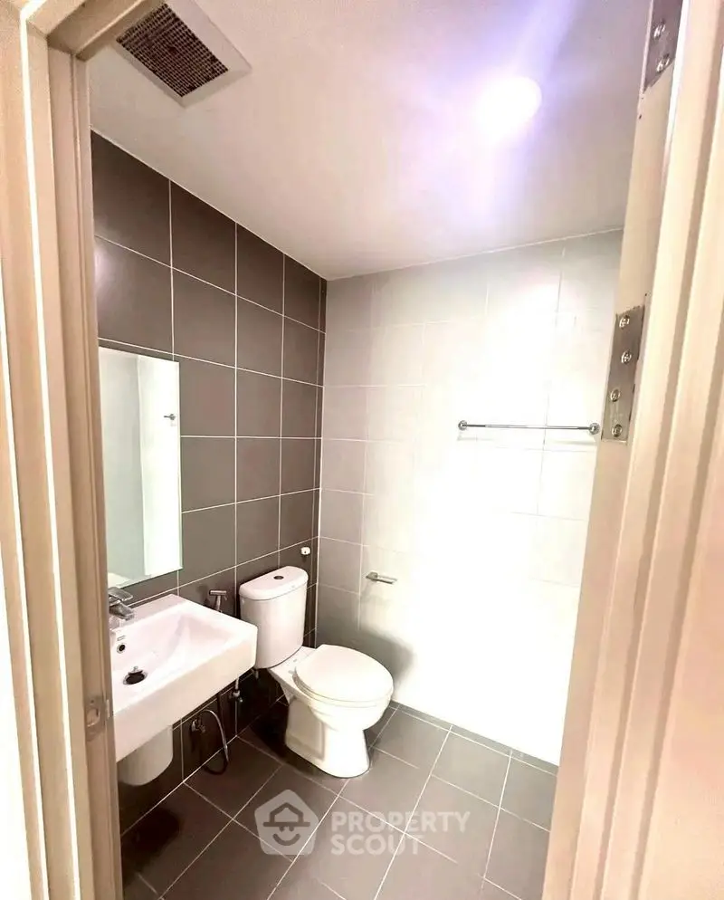 Modern bathroom with sleek tiles and contemporary fixtures.